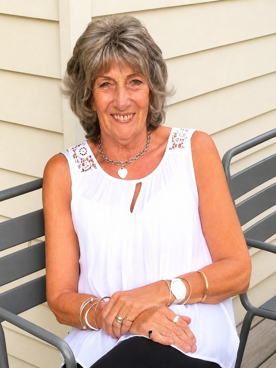 Barbara Ferriman, seated and smiling